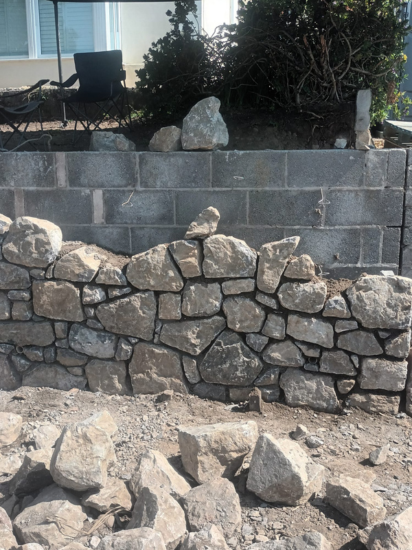 a stone wall being built