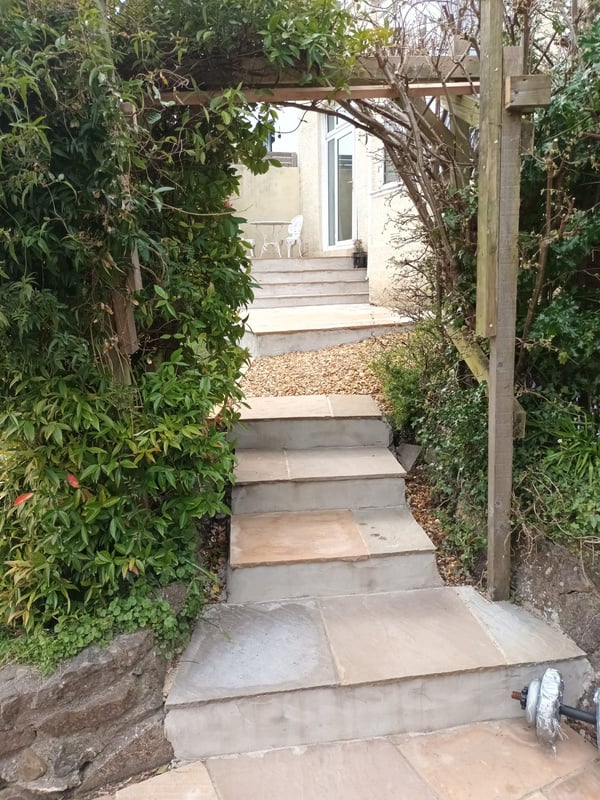 steps leading through a hedge