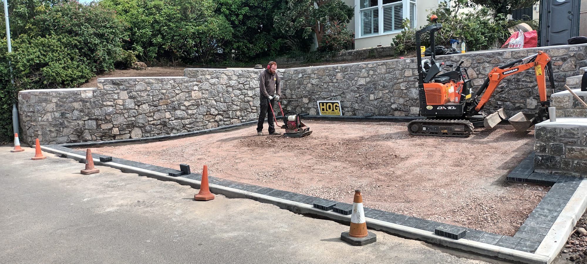 Kim, a man using machinery on a driveway