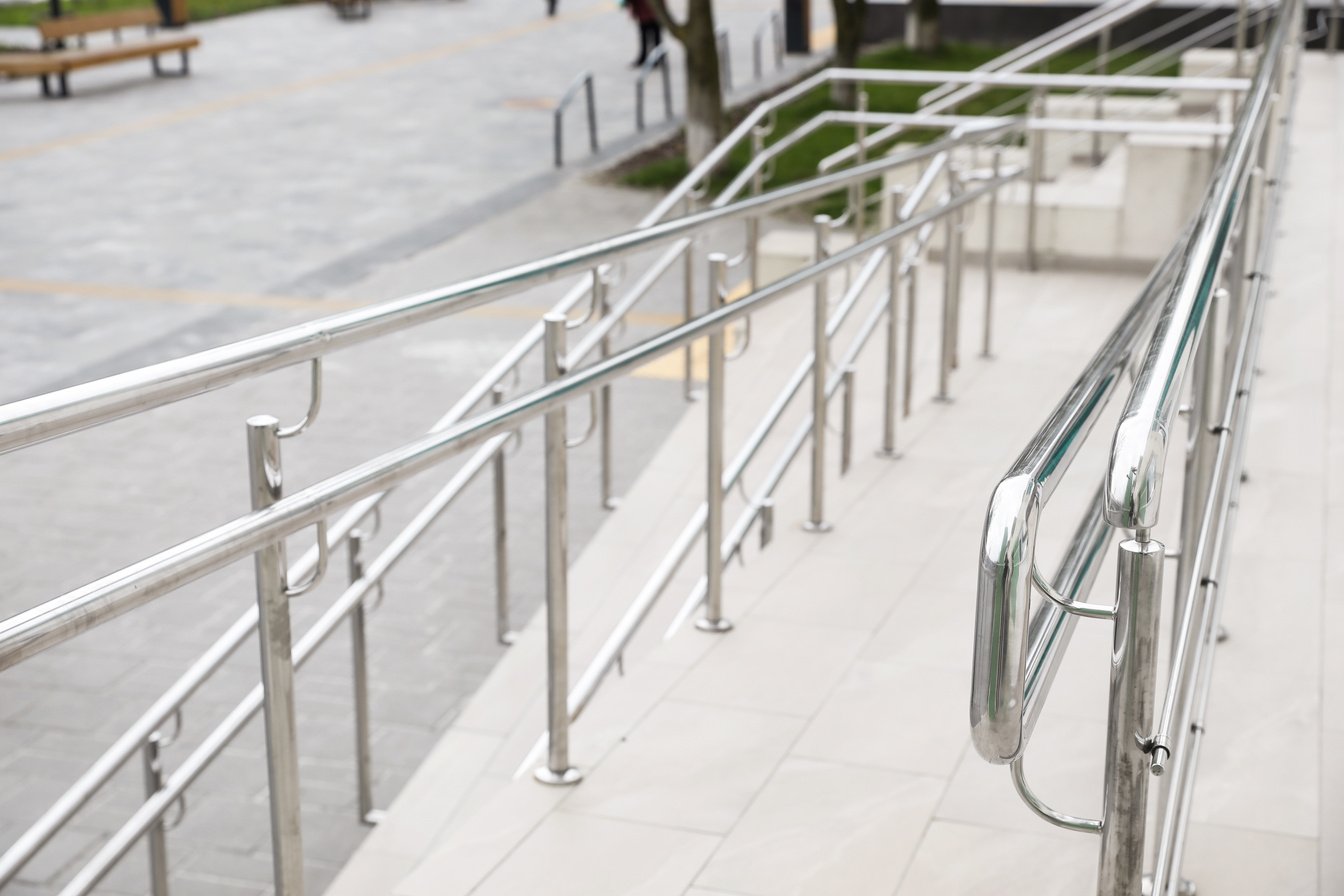 Tiled Ramp with Shiny Metal Railings Outdoors